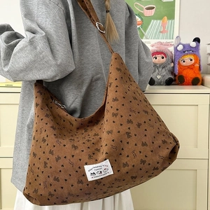 Brown corduroy hobo shoulder bag with black heart and bow prints for women