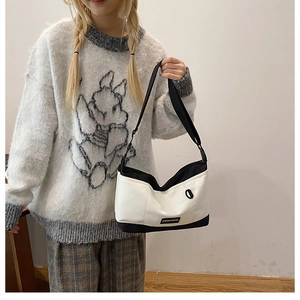 Detail view of the durable canvas crossbody bag showing the adjustable wide shoulder strap
