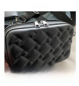 Detail showing the matte leather texture and cross-quilted stitching of the black crossbody bag