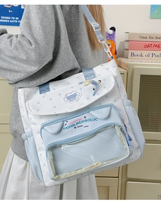 Close-up of stylish canvas student messenger bag with star patterns and clear pocket