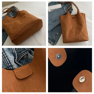 Dettaglio della borsa tote in pelle scamosciata marrone con chiusura magnetica e cuciture
