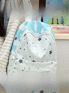 Detail of light blue star print backpack with front pocket for school and travel use