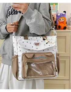 Detail of canvas bag with transparent window pocket and decorative heart patterns