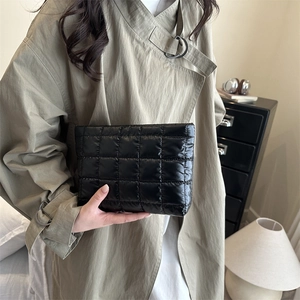Fashionable black quilted puffer clutch bag with minimalist pleated texture for women