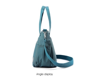 Side view of multi-purpose nylon tote bag showing zipper pockets and adjustable strap