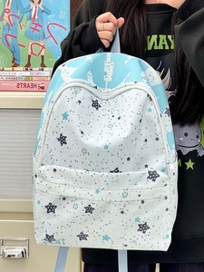 Detailed close-up of a student backpack featuring blue star patterns and campus style