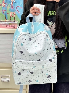 Detail view of large star print backpack with blue canvas and white zipper pocket