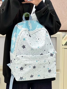 Detail view of large capacity star print backpack with blue and white geometric patterns