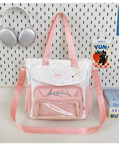 Detail of cute pink and white tote bag with cat-ear pocket and clear display window