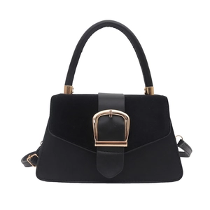 Minimalist black square handbag with trapezoid shape and large gold metal buckle