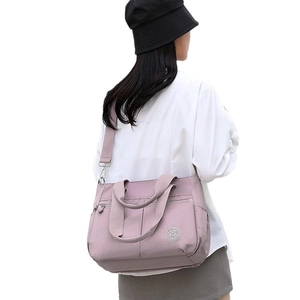 Minimalist light purple nylon tote bag with multiple zip pockets and adjustable shoulder strap