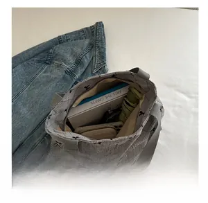 Grande borsa tote in velluto a coste grigio che mostra capienza con libri e accessori