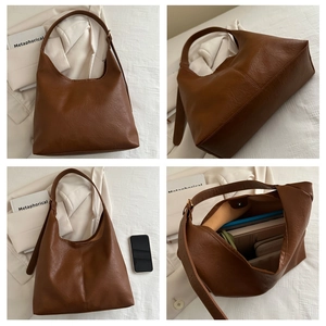 Detail view of brown Hobo bag showing litchi texture, adjustable strap and spacious interior