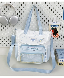 Detail of light blue and white student bag with transparent window and star pattern