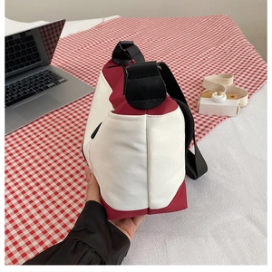 Side view of small color-block canvas messenger bag with wide capacity and nylon strap