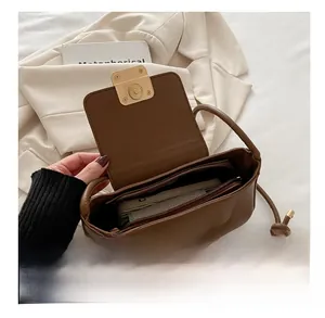 Detail view of the deep brown leather shoulder bag interior with multi-layer storage compartments