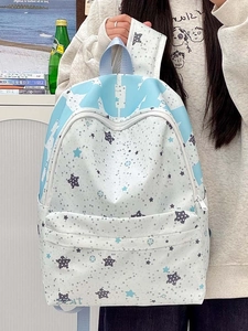 Detail of light blue star print canvas backpack featuring spacious front zipper pocket