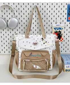 Detail view of canvas tote bag featuring transparent window pocket and star patterns