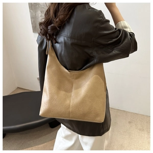 Detail showing the pleated texture and beige PU leather finish of the chic hobo shoulder bag