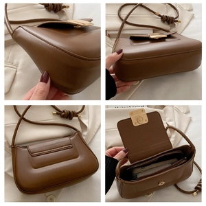 Detail view of brown faux leather bag showing golden magnetic buckle and inner zipper pocket
