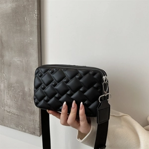 Fashionable black quilted shoulder bag with wide strap and shiny leather finish