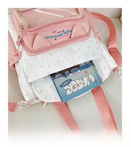 Detailed internal view of pink school bag front pocket showing storage capacity and cute cat ears