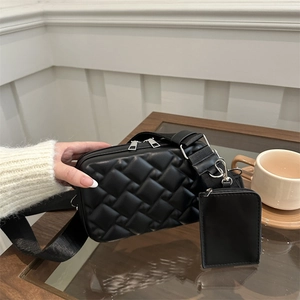 Chic black quilted crossbody bag with wide shoulder strap and detachable coin purse