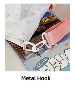 Detail of durable white metal hook and pink star printed canvas strap on bag