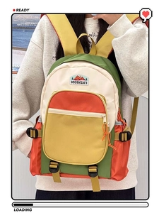 Detail of color-block nylon backpack with mountain patch and side adjustment buckle