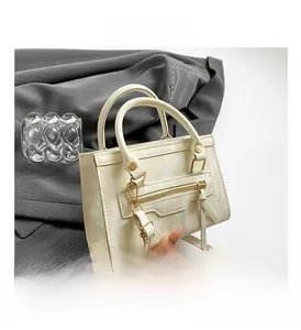 Detailed view of cream PU crossbody bag with marble texture and gold hardware details