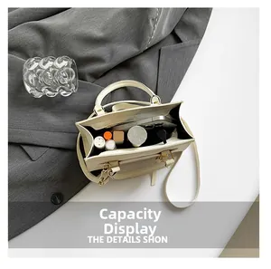 Top-view capacity display showing phone, lipstick and powder inside cream crossbody bag