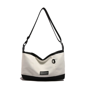 Fashionable black and white contrast canvas crossbody bag with adjustable strap