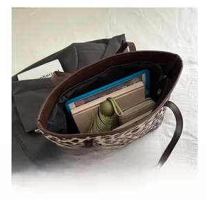 Interior view of leopard print tote bag showing capacity for tablet and daily items