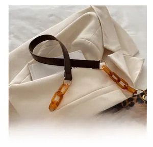 Detail of leopard print bag with amber acrylic chain and brown leather strap