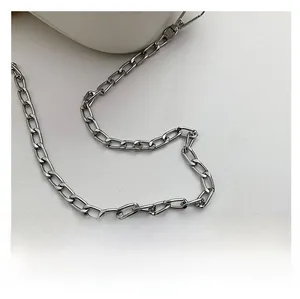 Detailed macro view of high-shine silver metal chain strap with swivel hook hardware