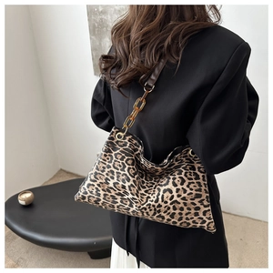Detail of leopard print tote bag with stylish amber acrylic chain shoulder strap