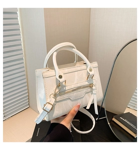 Detailed view of cream marble texture handbag with gold hardware and long tassel zip puller