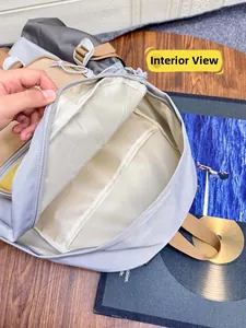 Interior view of color-block nylon backpack featuring a laptop sleeve and drawstring closure