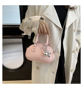 Pink leather mini bowling bag with silver chain and cute balloon dog charm detail