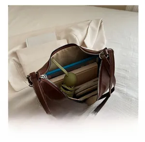 Interior view of large brown leather tote bag showing high capacity for daily essentials