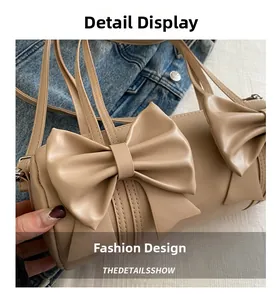 Detailansicht der beige Zylindertasche mit modischen großen Doppelschleifen-Akzenten