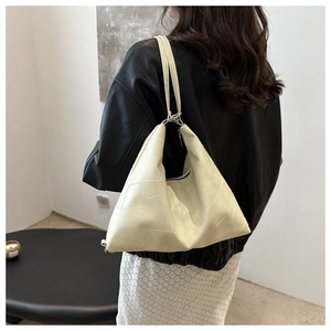 Detail view of the cream white geometric paneled tote bag with premium leather texture