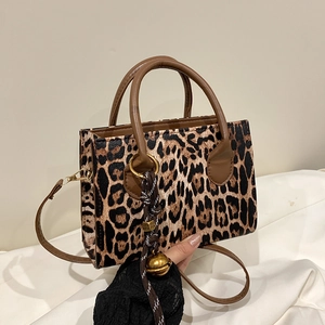 Retro leopard print handbag with brown handles and a gold bell charm for women