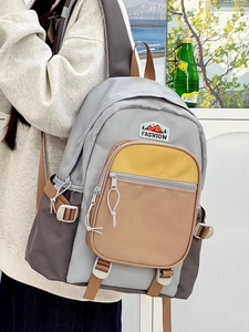 Lightweight color-block nylon backpack in grey, brown, and ginger with mountain embroidery