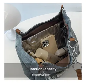 Detail shot of grey canvas tote bag interior showing large capacity for laptop and daily items