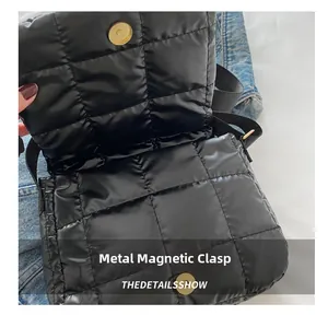 Close-up of black quilted bag featuring a secure golden magnetic snap closure detail