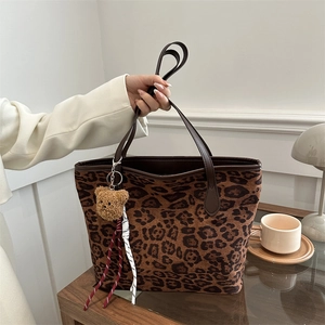 Retro leopard print tote bag with plush bear charm and brown leather handles