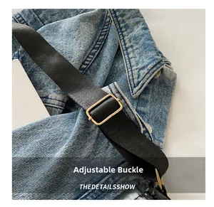 Detail shot of the golden rectangular adjustable metal buckle on a black nylon bag strap