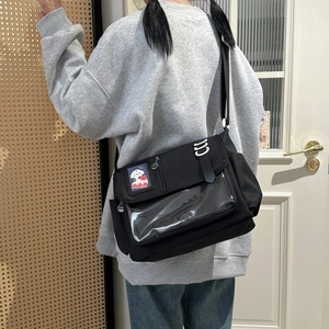 Detail of black canvas ita bag with clear window and cute puppy strawberry patch decoration