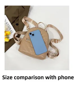 Detailed size comparison of beige quilted mini backpack next to a smartphone
